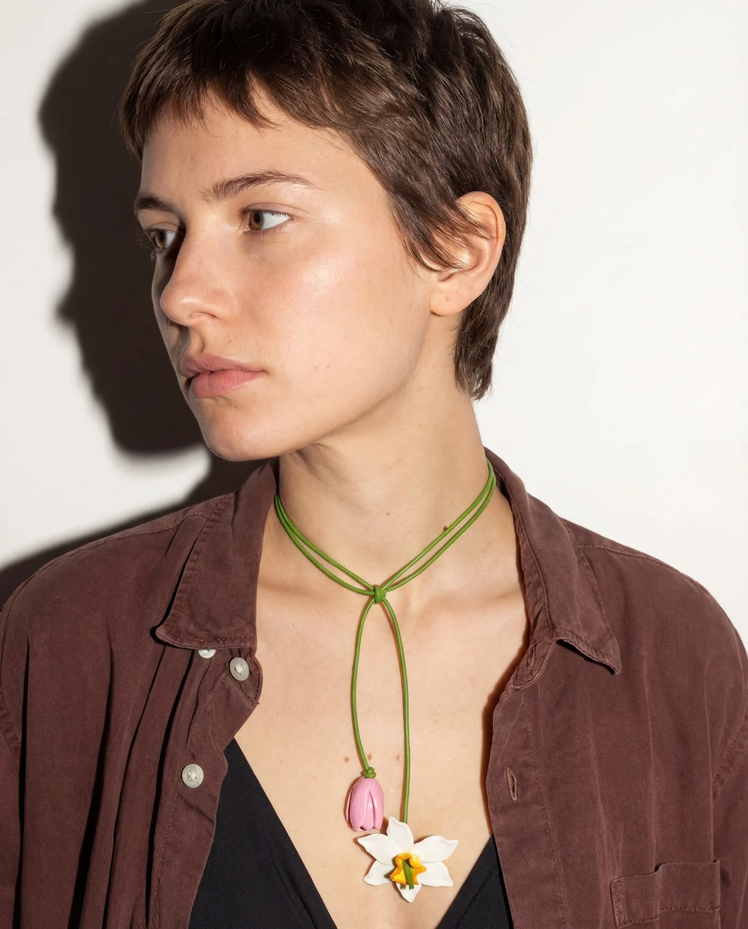 Editorial shoot — a model in a portrait scene with a pendant