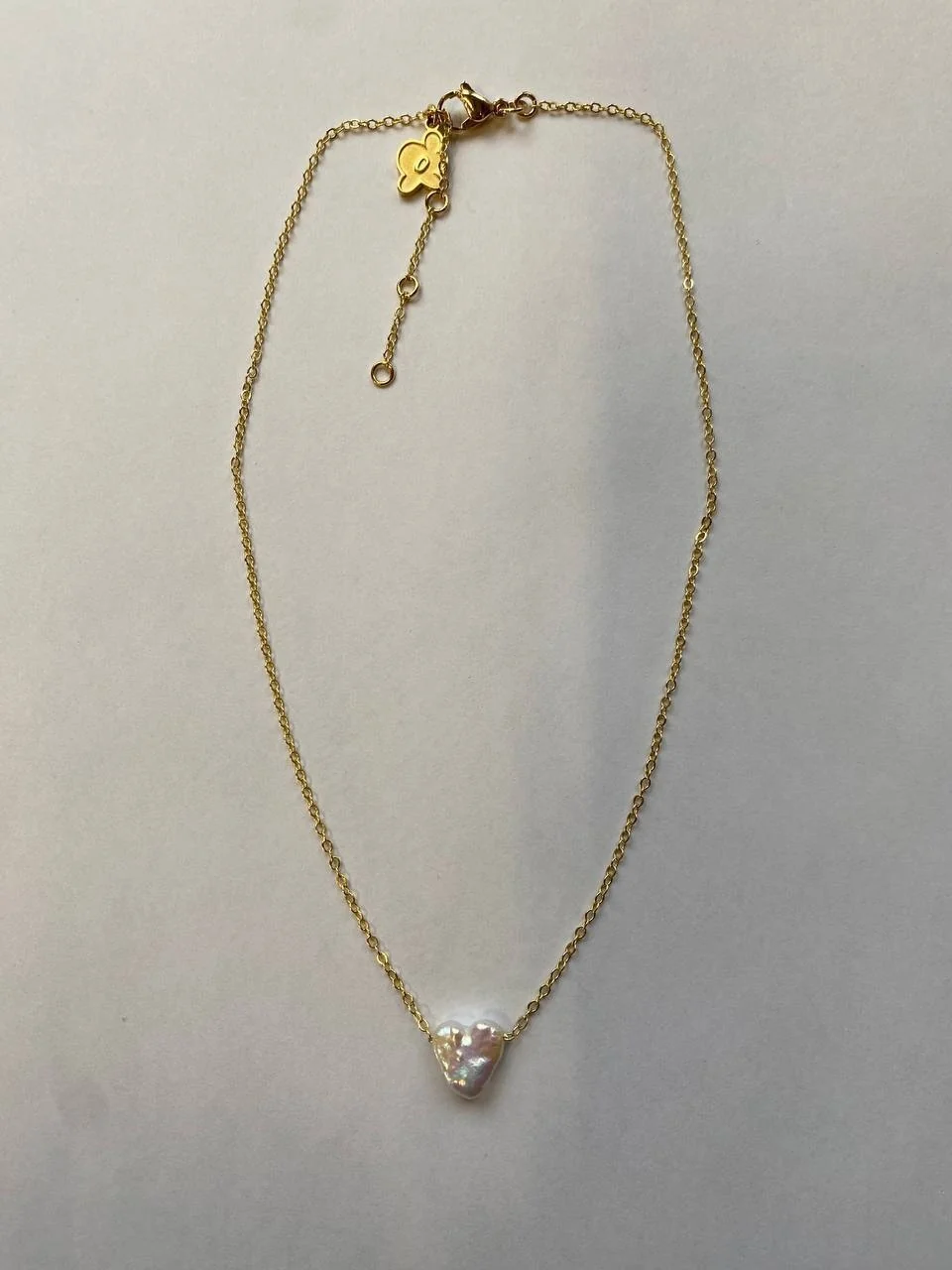 The same pendant, shot on a phone