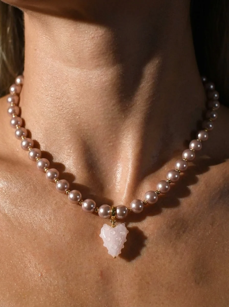 AI try-on — a model wearing a pink pearl necklace
