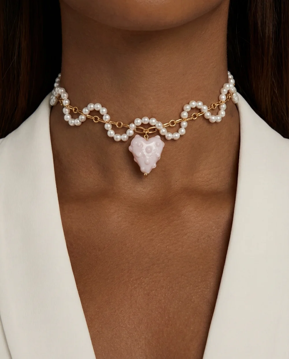 AI try-on: a model in a pearl necklace with a heart pendant